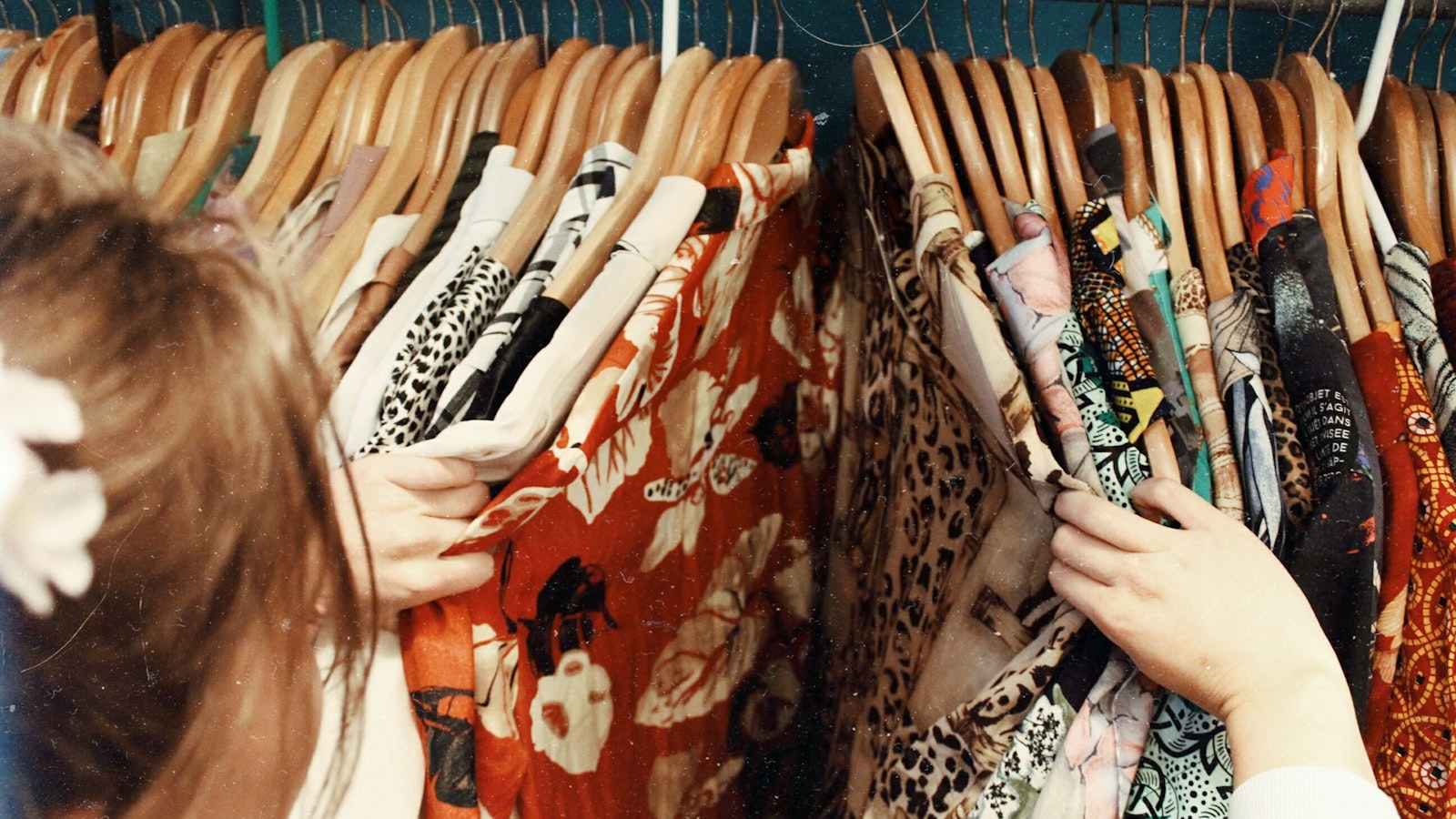 An organized clothing rail with garments neatly spaced on hangers.