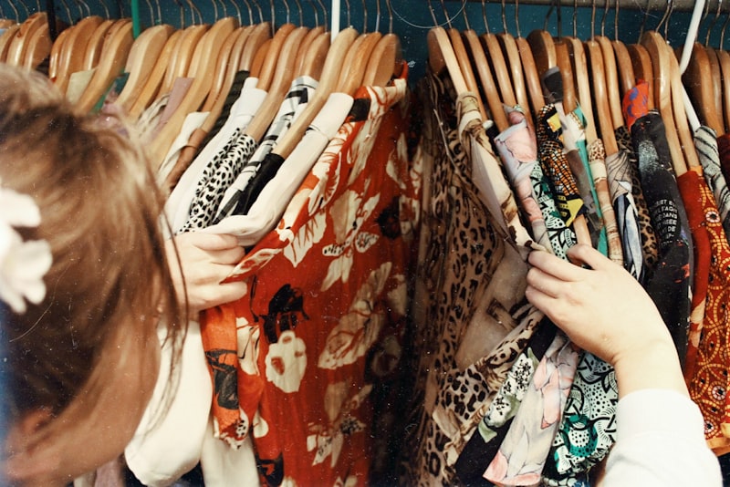 An organized clothing rail with garments neatly spaced on hangers.