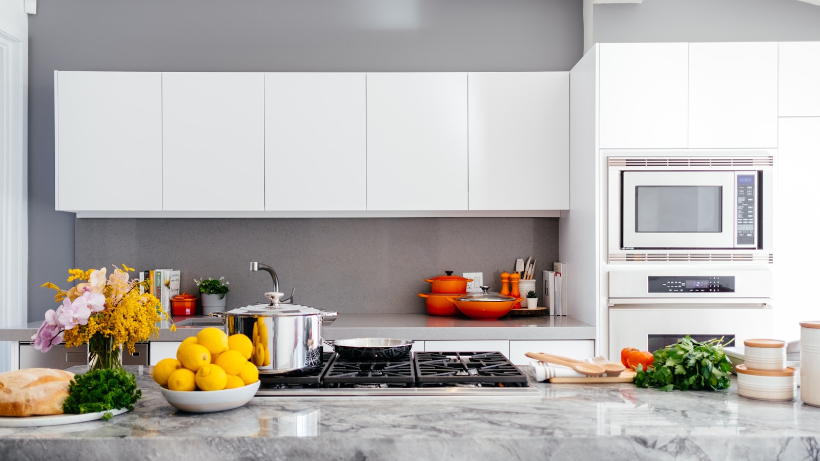 A tidy kitchen with clear counters, a clean sink, and neatly arranged utensils.
