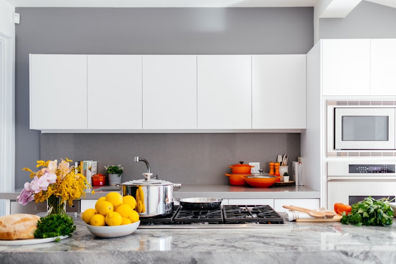 A tidy kitchen with clear counters, a clean sink, and neatly arranged utensils.
