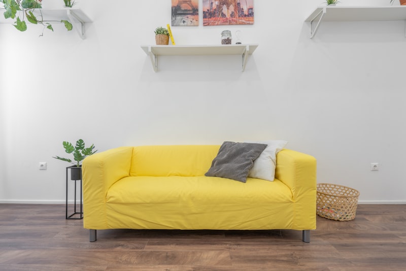 A simple home entryway with wall hooks holding coats and bags.