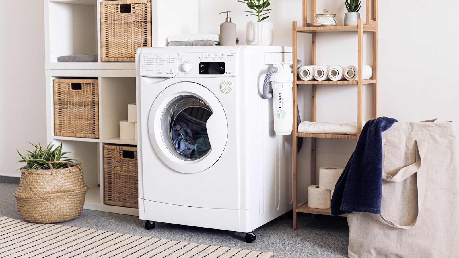 An organized laundry room with baskets, shelves, and neatly kept supplies.