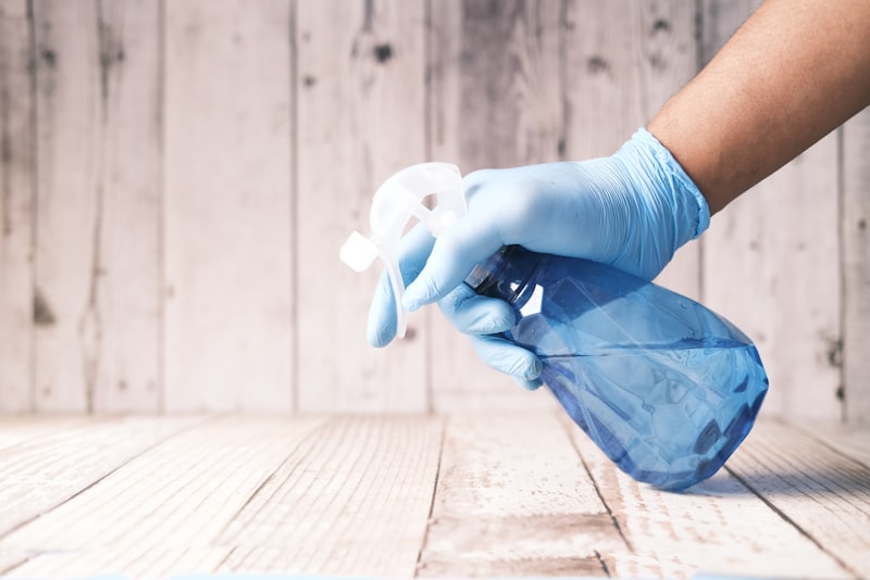 A mop cleaning a wooden floor in a bright, tidy room.
